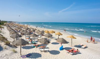 Sandy beach with thatched parasols at El Mouradi Cap Mahdia Sandy beach with thatched parasols at El Mouradi Cap Mahdia