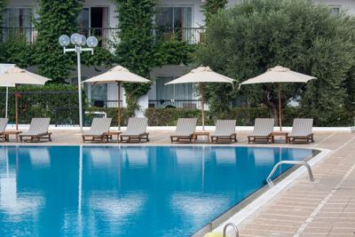 Swimming pool with parasols and loungers at El Mouradi Gammarth Swimming pool with parasols and loungers at El Mouradi Gammarth