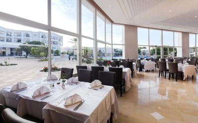 Restaurant with floor-to-ceiling windows at El Mouradi Gammarth Restaurant with floor-to-ceiling windows at El Mouradi Gammarth