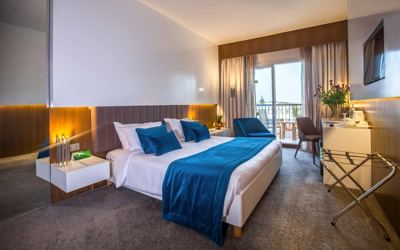Business room with blue bed runner at El Mouradi Gammarth Business room with blue bed runner at El Mouradi Gammarth