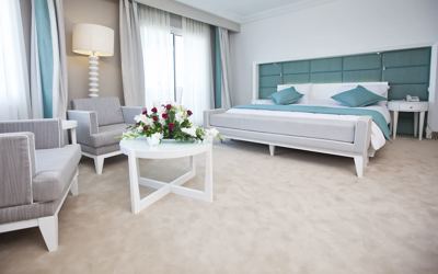 Superior room with double bed and seating area at El Mouradi Hammamet