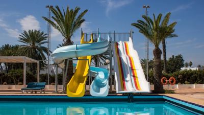 Water slides beside the swimming pool at El Mouradi Club Selima Water slides beside the swimming pool at El Mouradi Club Selima