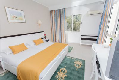 Double room with yellow bed runner at El Mouradi Club Selima Double room with yellow bed runner at El Mouradi Club Selima