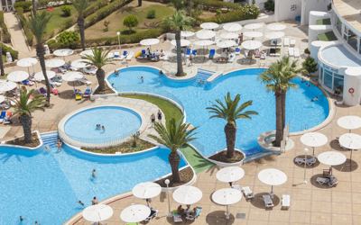 Swimming pools and sun umbrellas seen from above at El Mouradi Skanes Swimming pools and sun umbrellas seen from above at El Mouradi Skanes