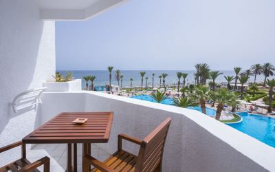 Room balcony with pool and sea view at El Mouradi Skanes Room balcony with pool and sea view at El Mouradi Skanes